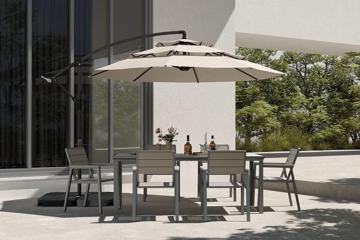 Outdoor dining table with chairs and large patio umbrella on a balcony.