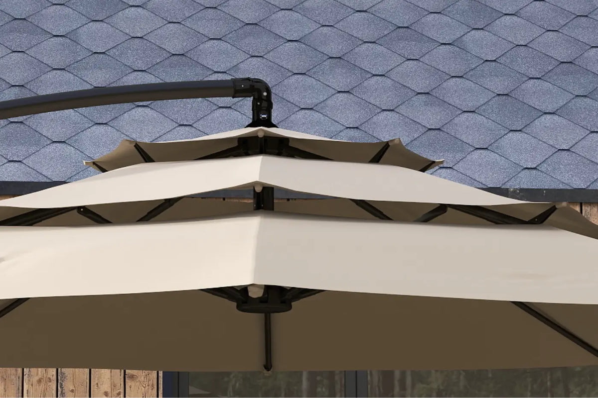 White patio umbrella with black frame against a blue tiled roof background