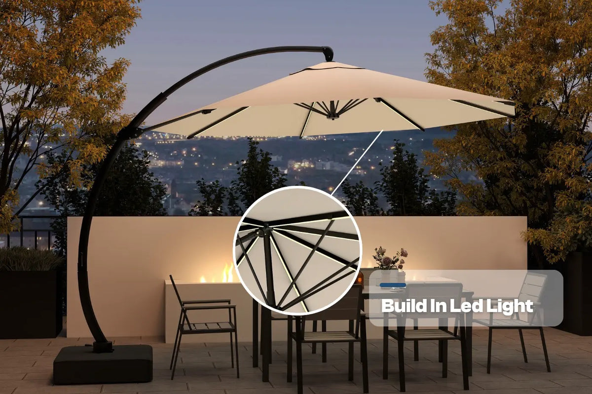 Beige patio umbrella with built-in LED light on a stand, set against a scenic background.