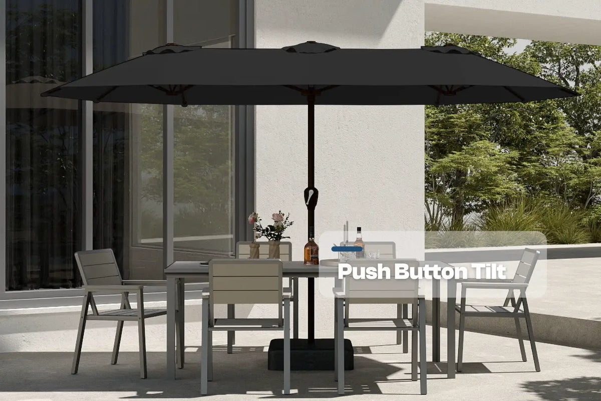 Outdoor patio set with a large black umbrella on a patio with trees in the background