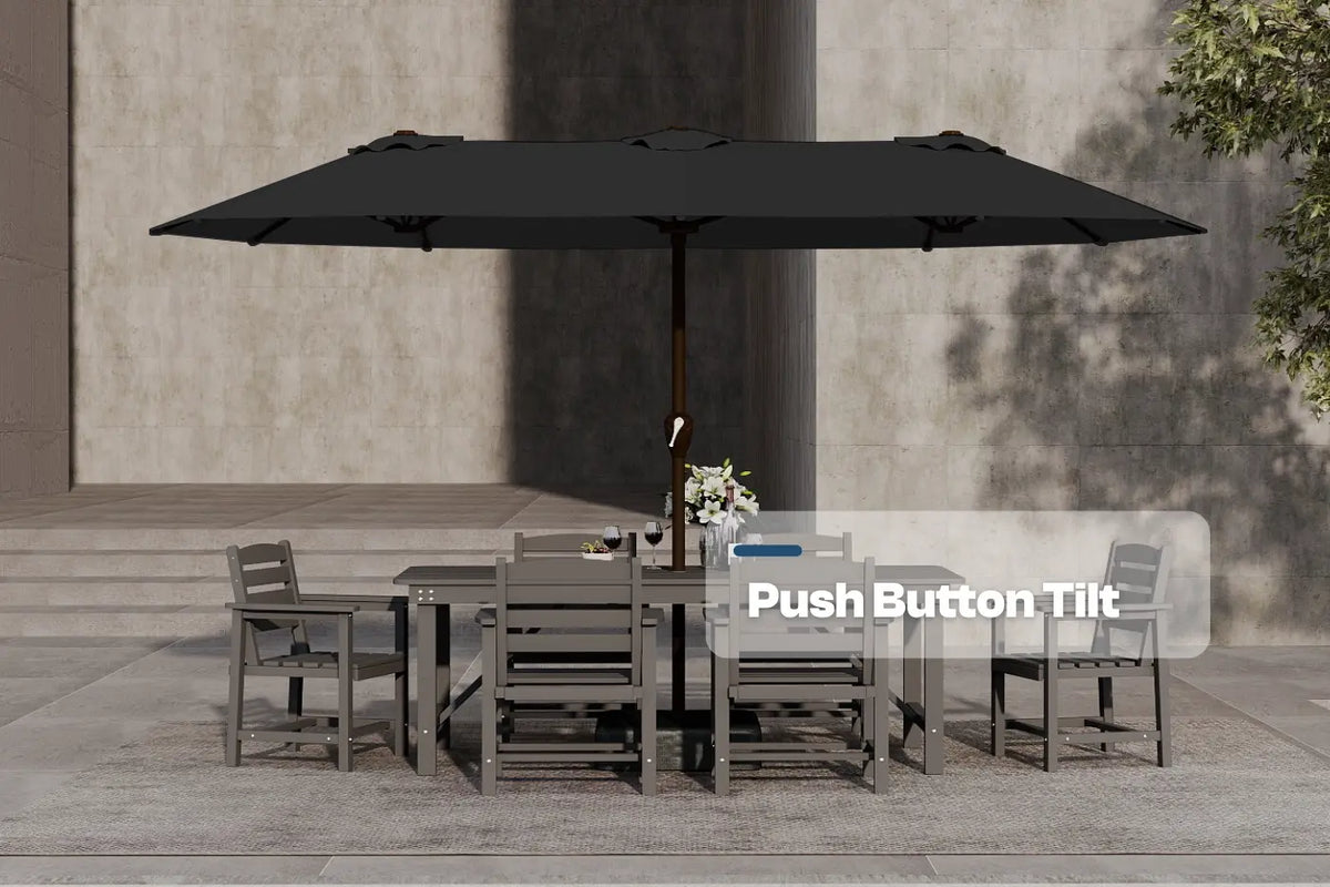 Outdoor dining set with a large black umbrella on a patio.