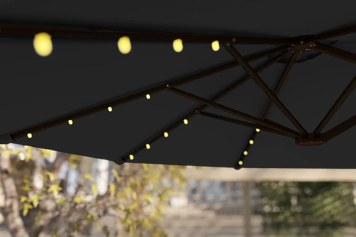 Black outdoor umbrella with string lights against a blurred background