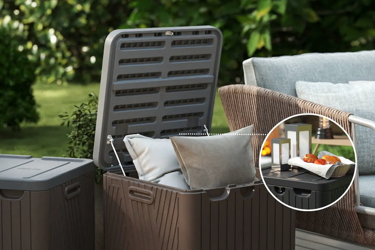 Outdoor storage bin with a lid open, showing cushions inside, with a blurred background of outdoor furniture.