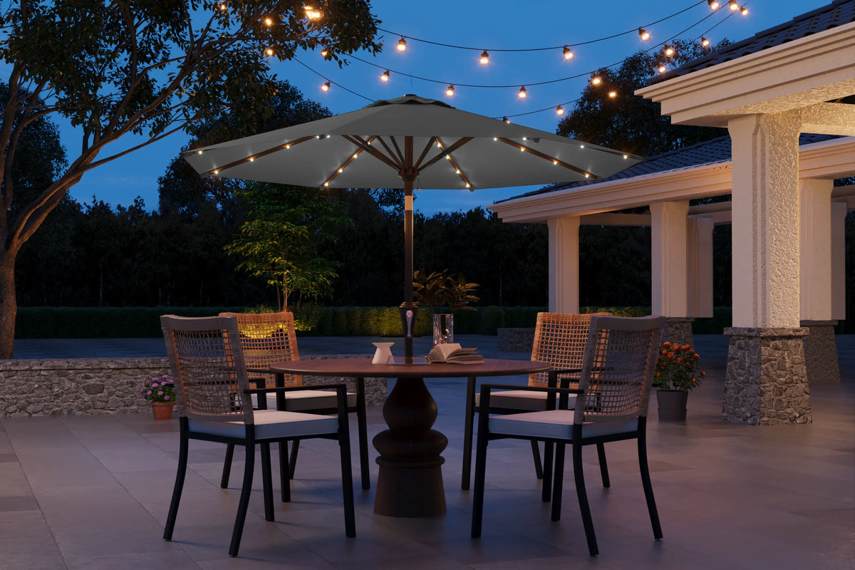 Outdoor patio setting with table, chairs, and string lights at dusk.
