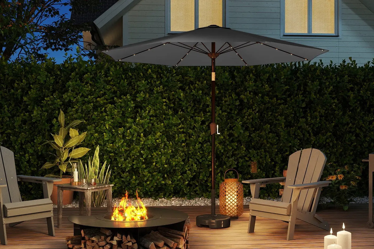 Outdoor patio setting with a fire pit, chairs, and an umbrella on a wooden deck.