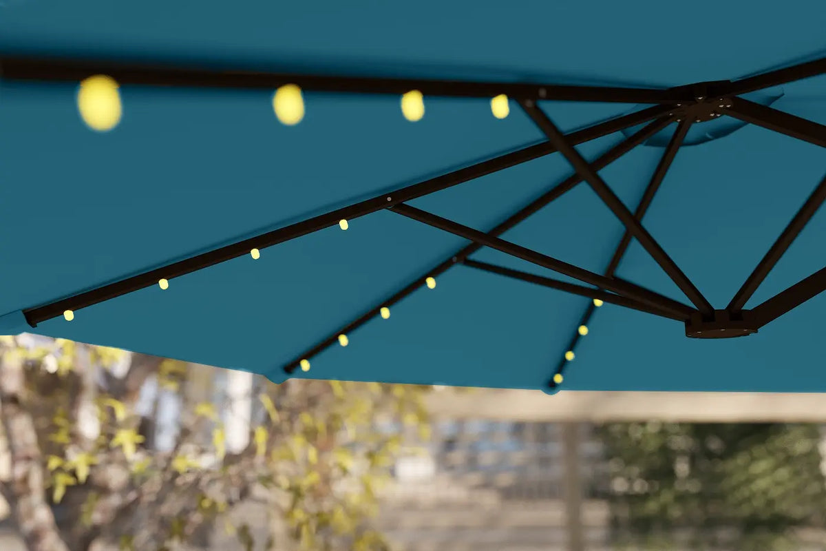 Blue patio umbrella with string lights against a blurred outdoor background