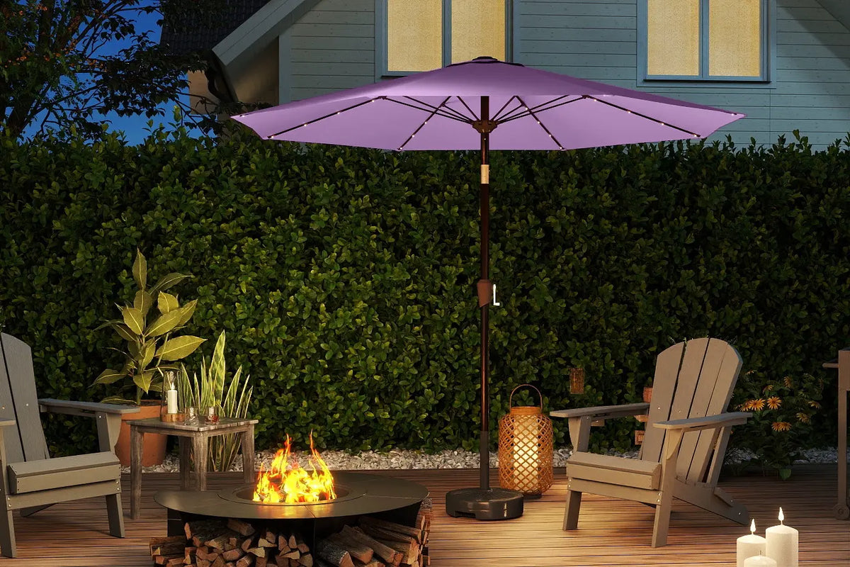 Purple patio umbrella over a fire pit with chairs and candles on a wooden deck.
