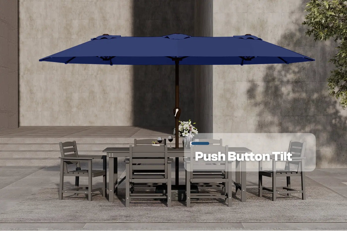 Blue patio umbrella with push button tilt feature over a dining set on a stone patio.