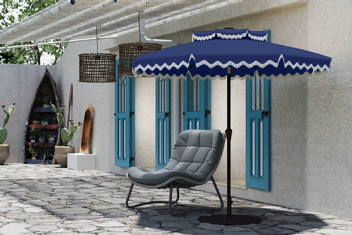 Blue outdoor umbrella with white trim over a gray chair on a patio.