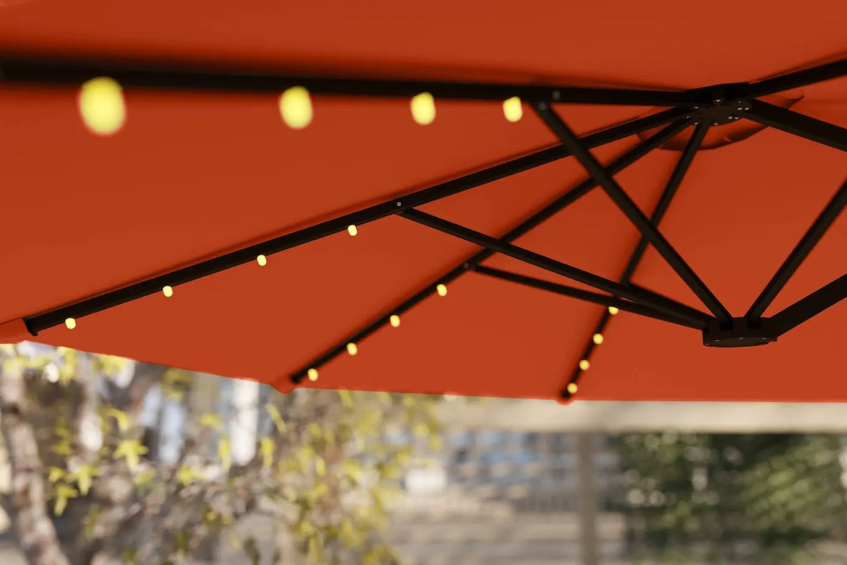 Red patio umbrella with string lights against a blurred outdoor background