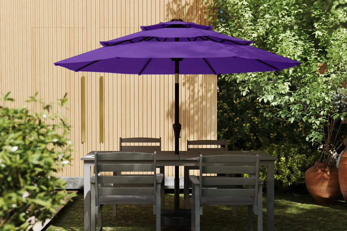 Purple patio umbrella over a table with chairs in a garden setting.