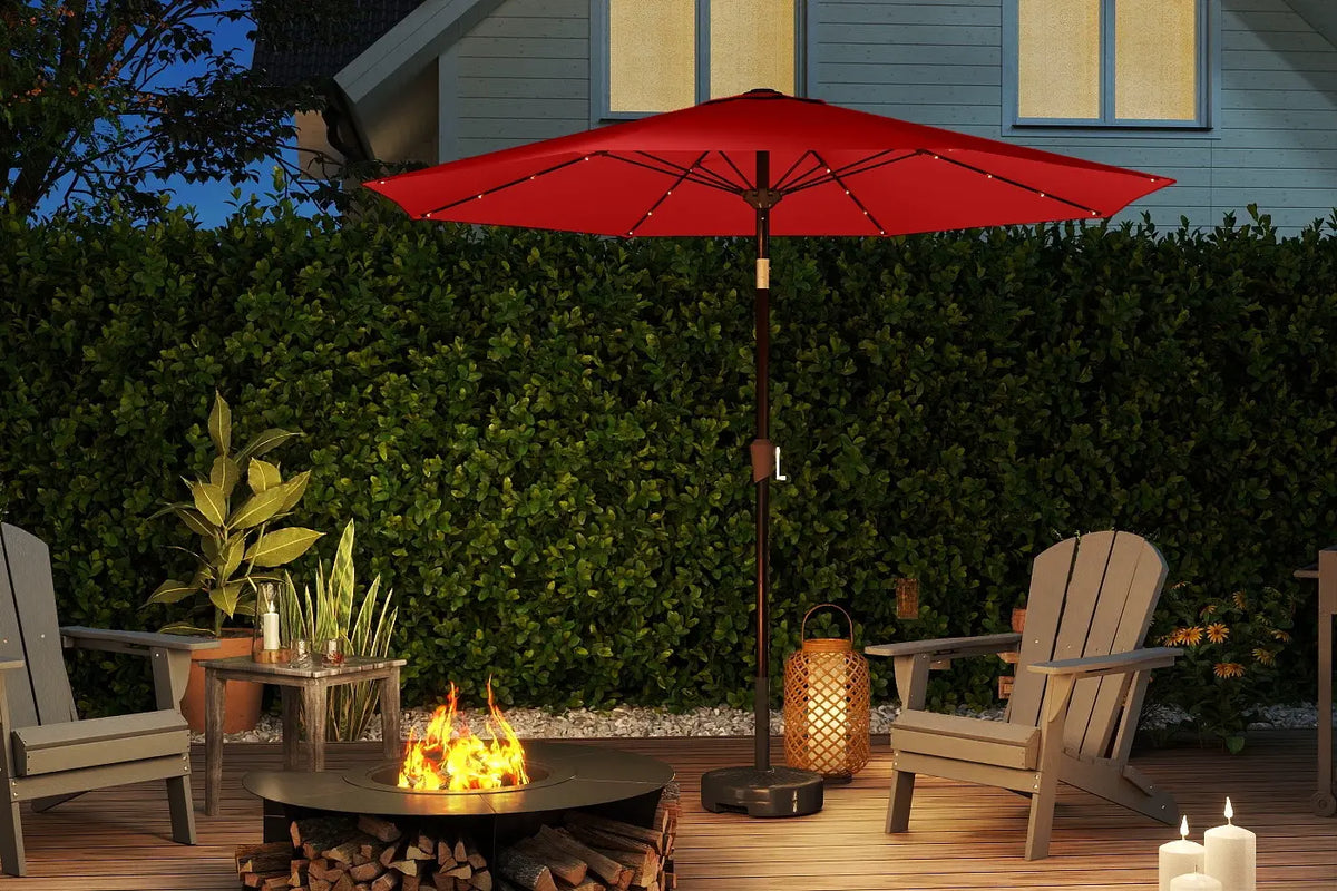 Outdoor patio setup with red umbrella, fire pit, chairs, and lanterns.