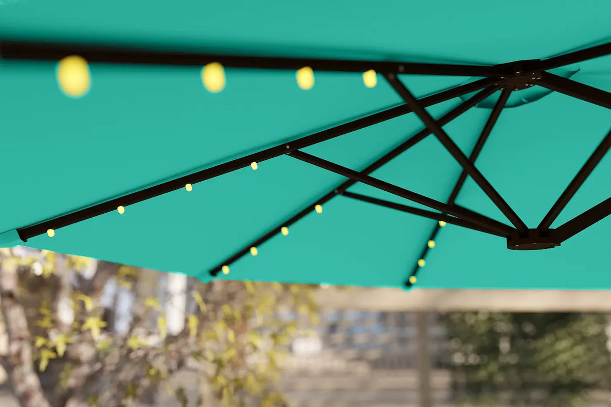 Teal patio umbrella with string lights against a blurred outdoor background