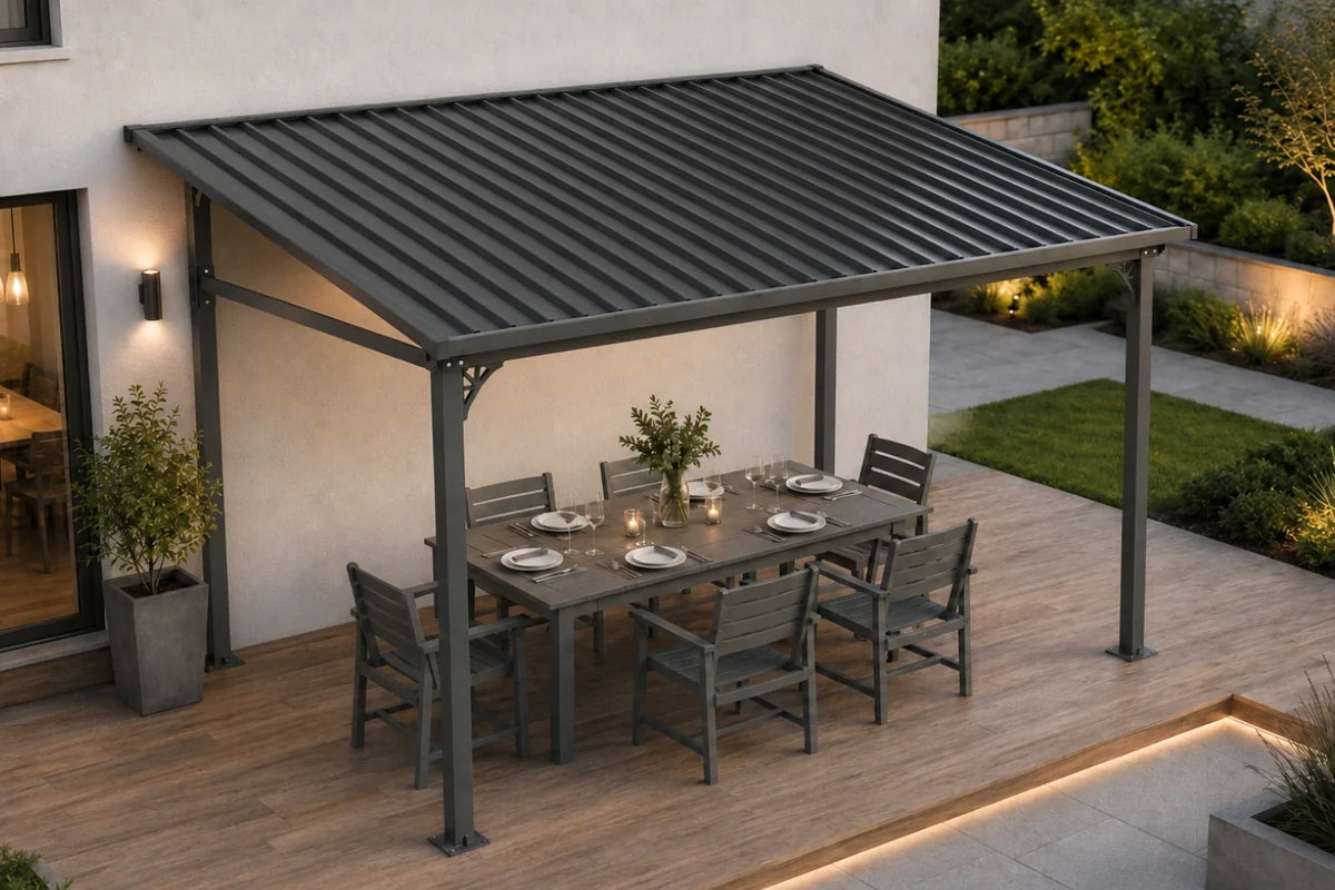 A dark gray wall-mounted hardtop gazebo over a dining table and six chairs on a wooden deck, set next to a modern house exterior.