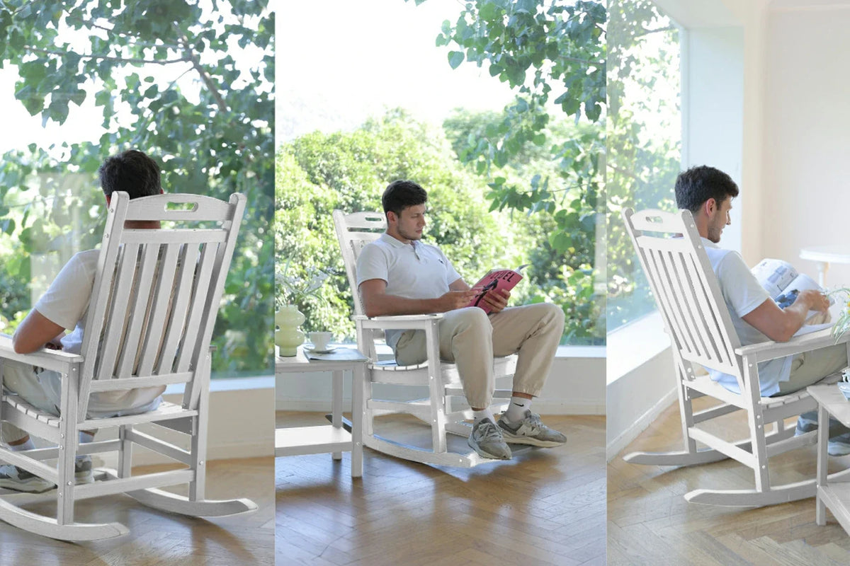 Man using a smartphone in a modern living room with a white rocking chair.
