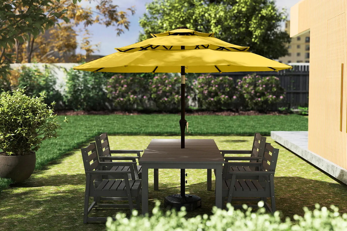 Outdoor patio set with a yellow umbrella and wooden table on a grassy area.