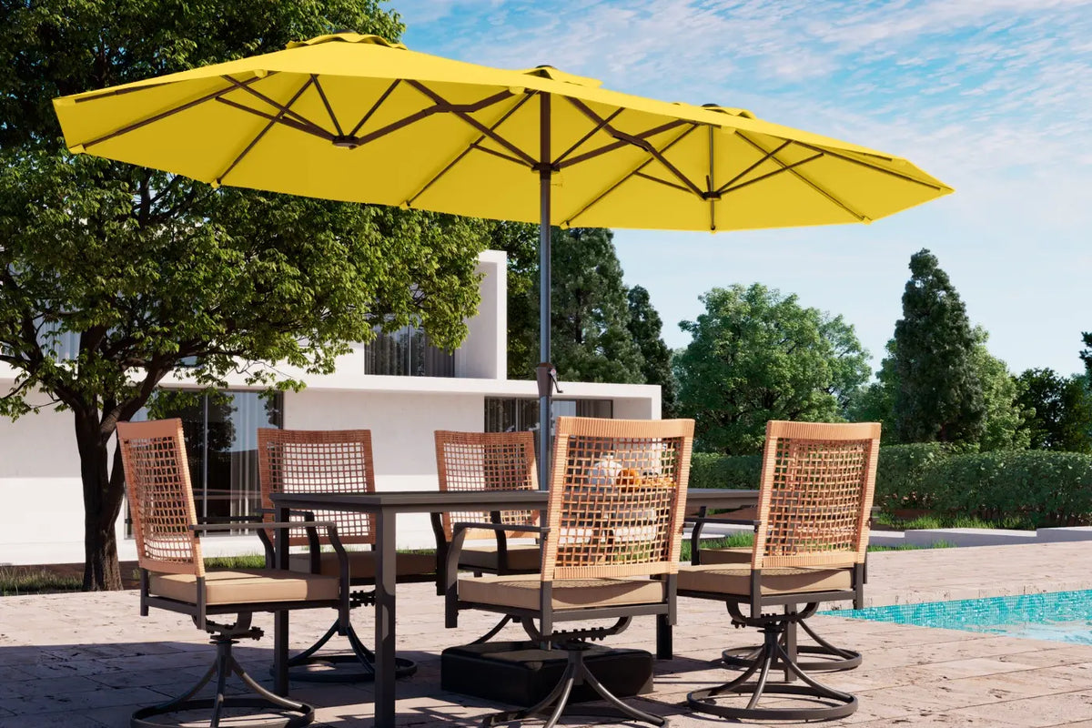 Outdoor dining set with a yellow umbrella by a poolside.