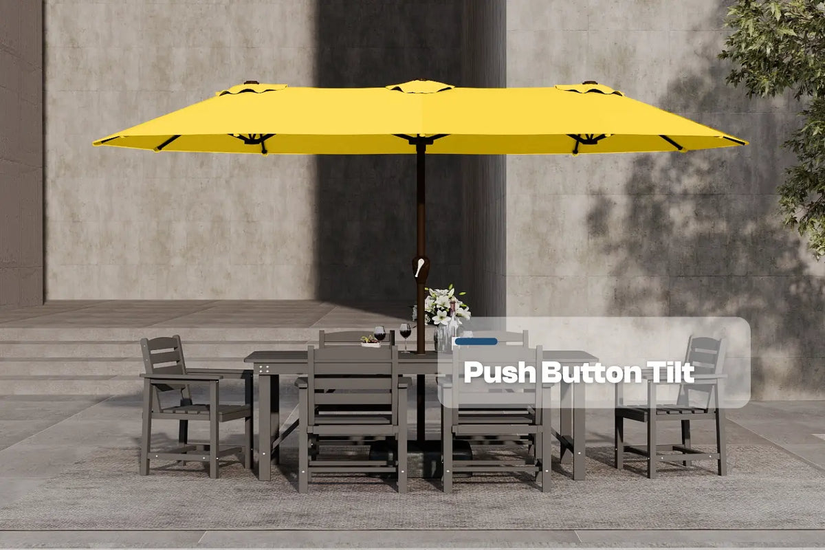Yellow patio umbrella with push button tilt feature over a dining table and chairs.
