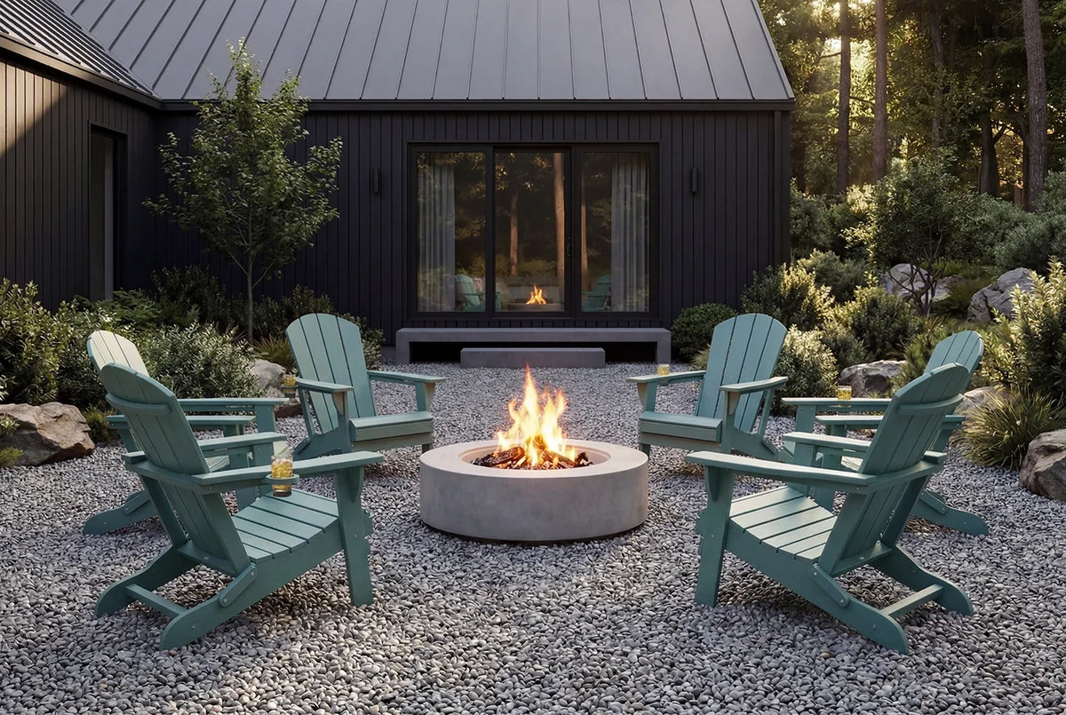 Outdoor setting with Adirondack chairs around a fire pit in front of a house.