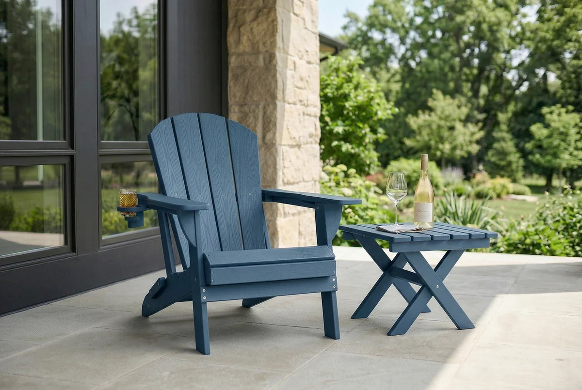 Blue Adirondack chair on a patio with a stone wall and greenery in the background