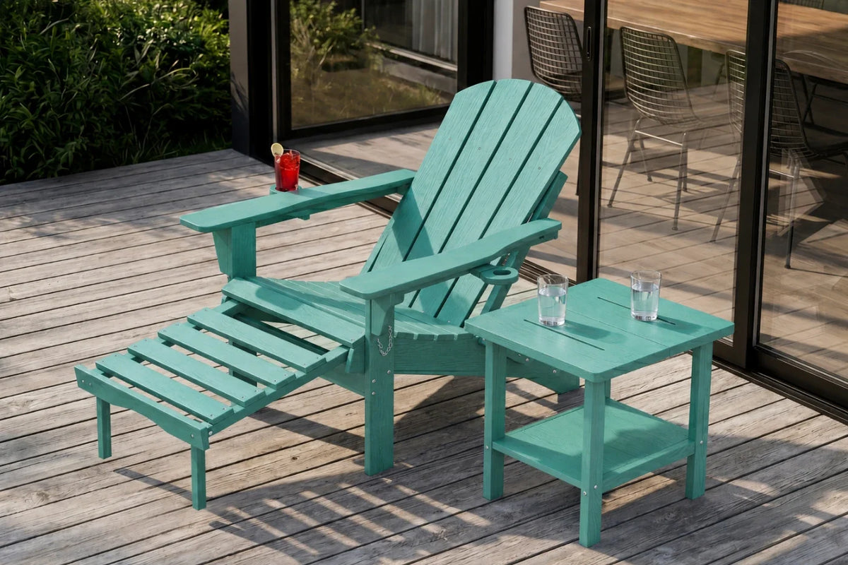 An aruba blue outdoor Adirondack chair with an integrated footrest and a matching side table, set on a wooden deck next to glass patio doors.
