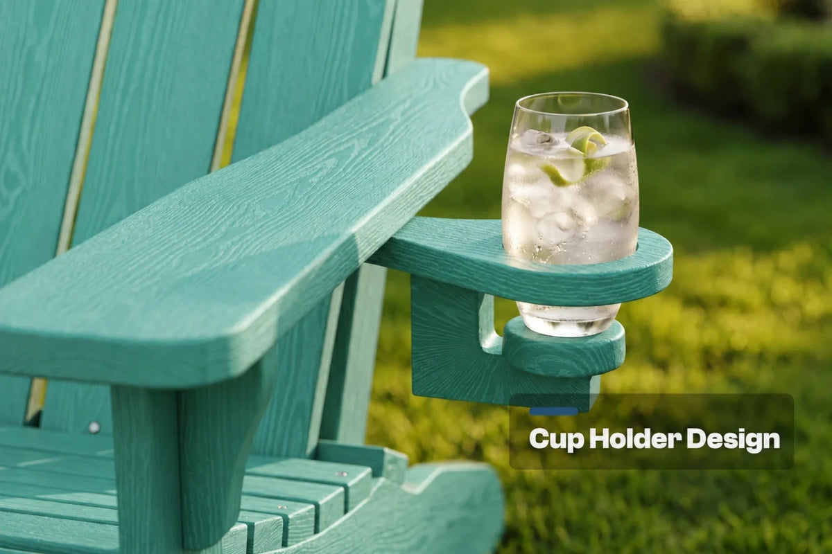A close-up of an aruba blue outdoor Adirondack chair arm with a built-in cup holder, holding a clear glass of iced water outdoors on a grassy lawn. White text overlay reads 'Cup Holder Design'.