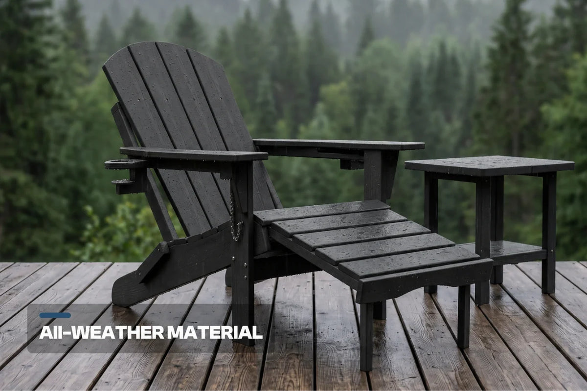 A black outdoor Adirondack chair with a matching side table and footrest set on a wooden deck, with a blurred forest background. A text overlay at the bottom left reads 'ALL-WEATHER MATERIAL'.