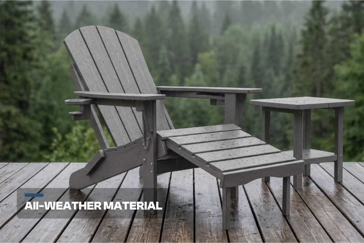 Dark gray outdoor Adirondack chair with matching side table on a wooden deck, with a blurred forest background and the text 'All-WEATHER MATERIAL' in the lower left corner.