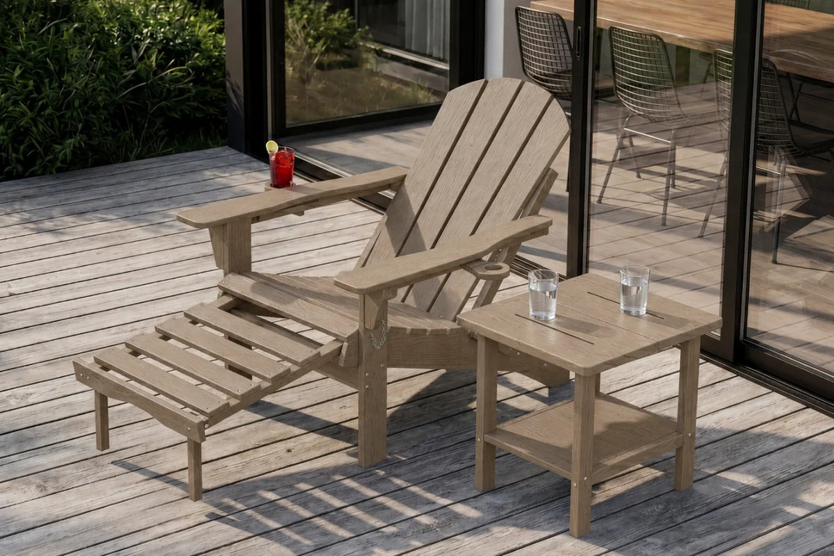 A light brown outdoor patio set consisting of a HDPE reclining adirondack chair with footrest, and a small side table on a wooden deck. The set is shown with a couple of clear drinking glasses on the table and a red drink on the chair arm.