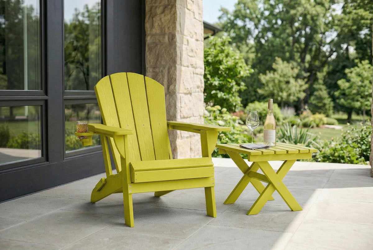 Yellow Adirondack chair and table on a patio with a view of trees and a building.