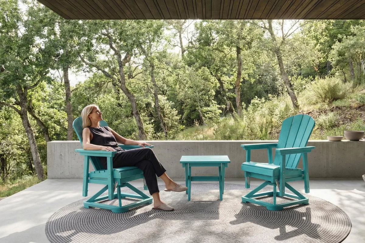 Woman sitting on a aruba blue chair in a patio setting with trees in the background