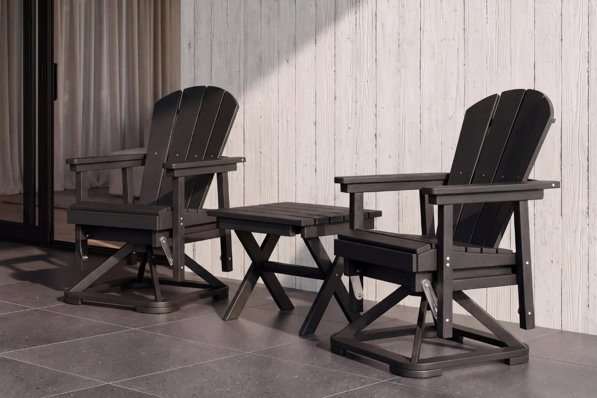 Two black Adirondack chairs with a matching table on a tiled floor.