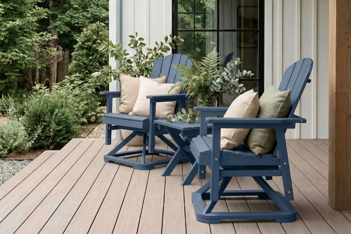 Two navy blue Adirondack chairs with cushions on a wooden deck.