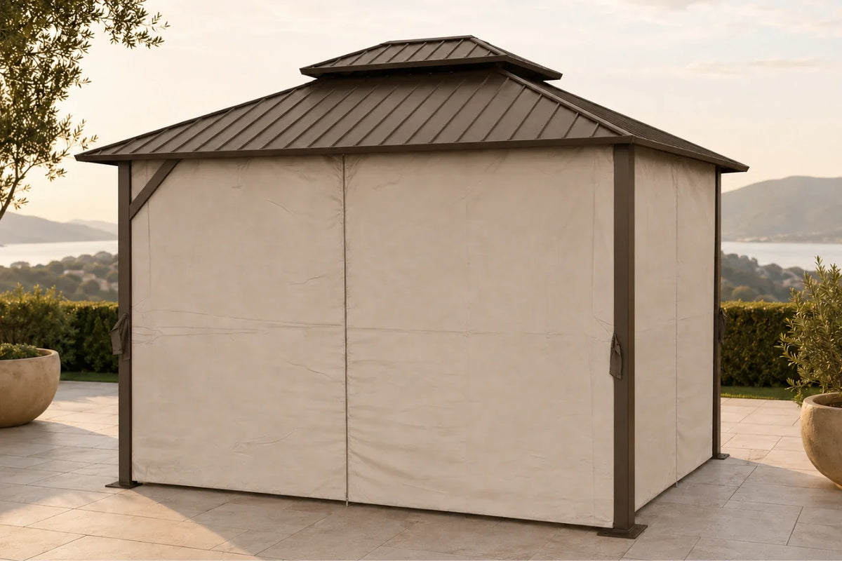 A covered hardtop gazebo with netting and curtains, situated on a stone patio with a scenic lake and hills in the background.