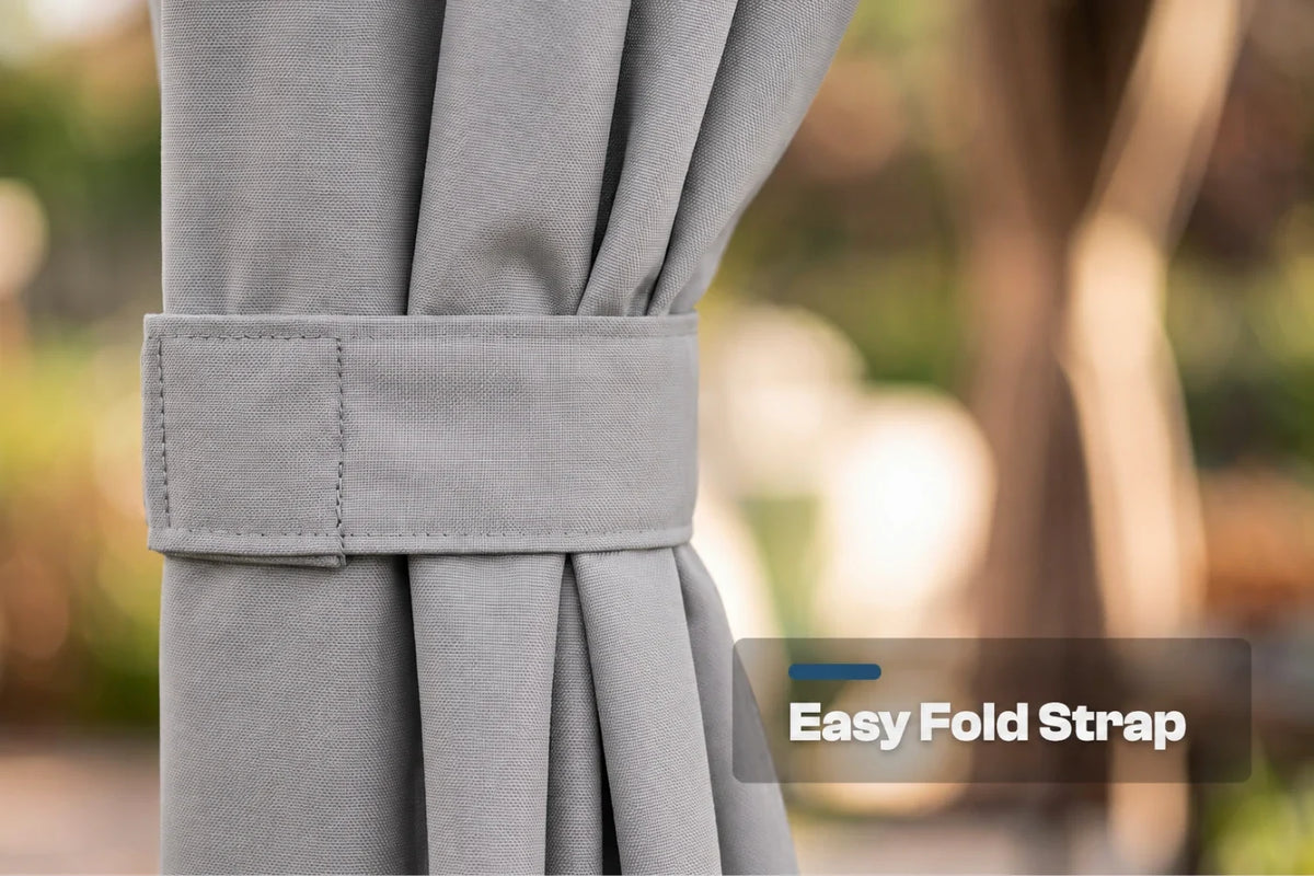 Close-up of a gray curtain tied back with a matching fabric strap, with a blurred outdoor background and an overlay label reading 'Easy Fold Strap'.