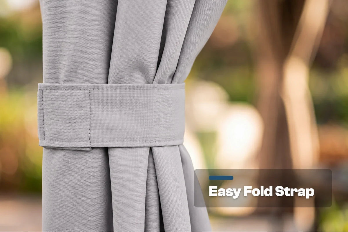 Close-up of a gray curtain tieback strap holding back pleated fabric, with a blurred outdoor background and a text label reading 'Easy Fold Strap'.