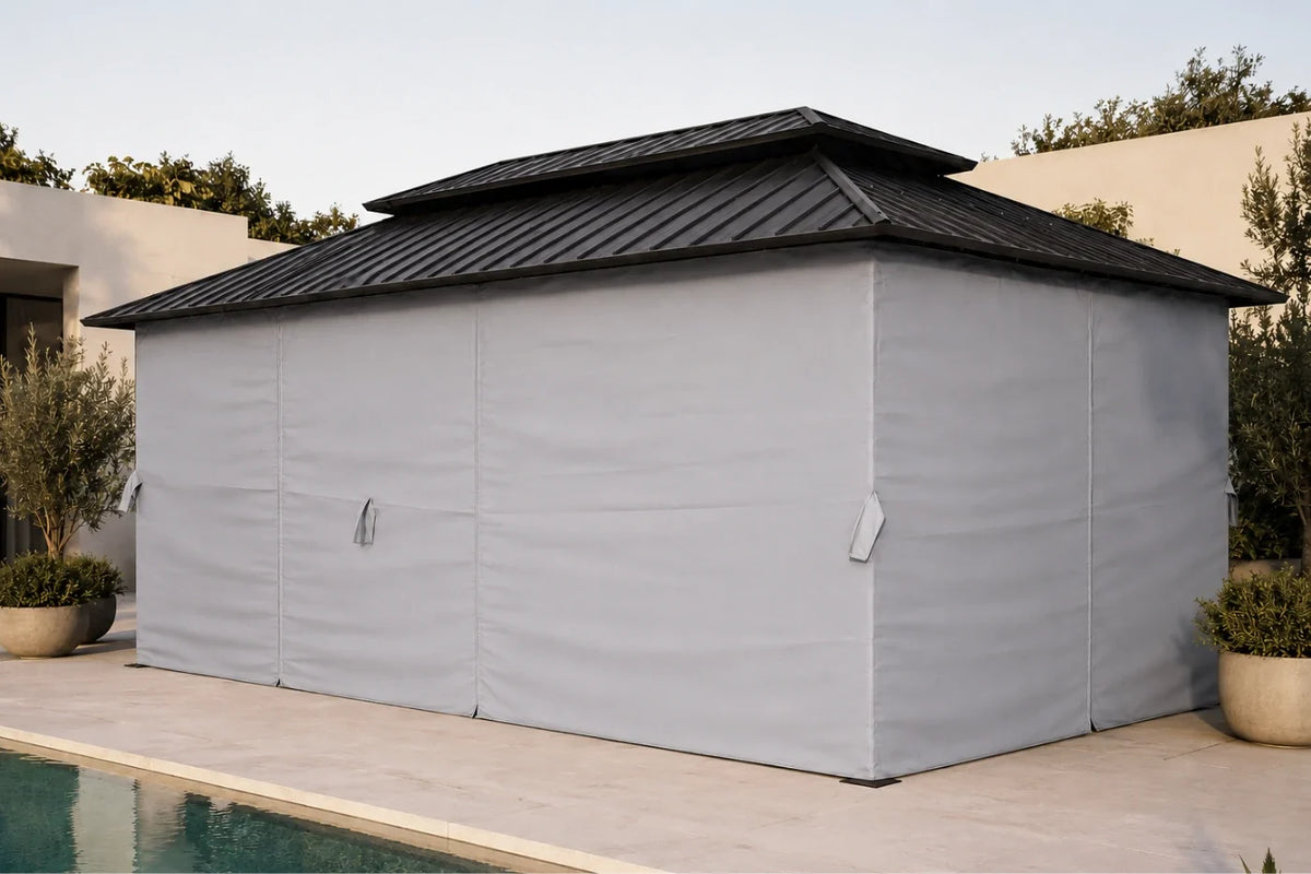A dark gray hardtop gazebo with netting and curtains, shown beside a pool on a patio in a modern backyard setting.