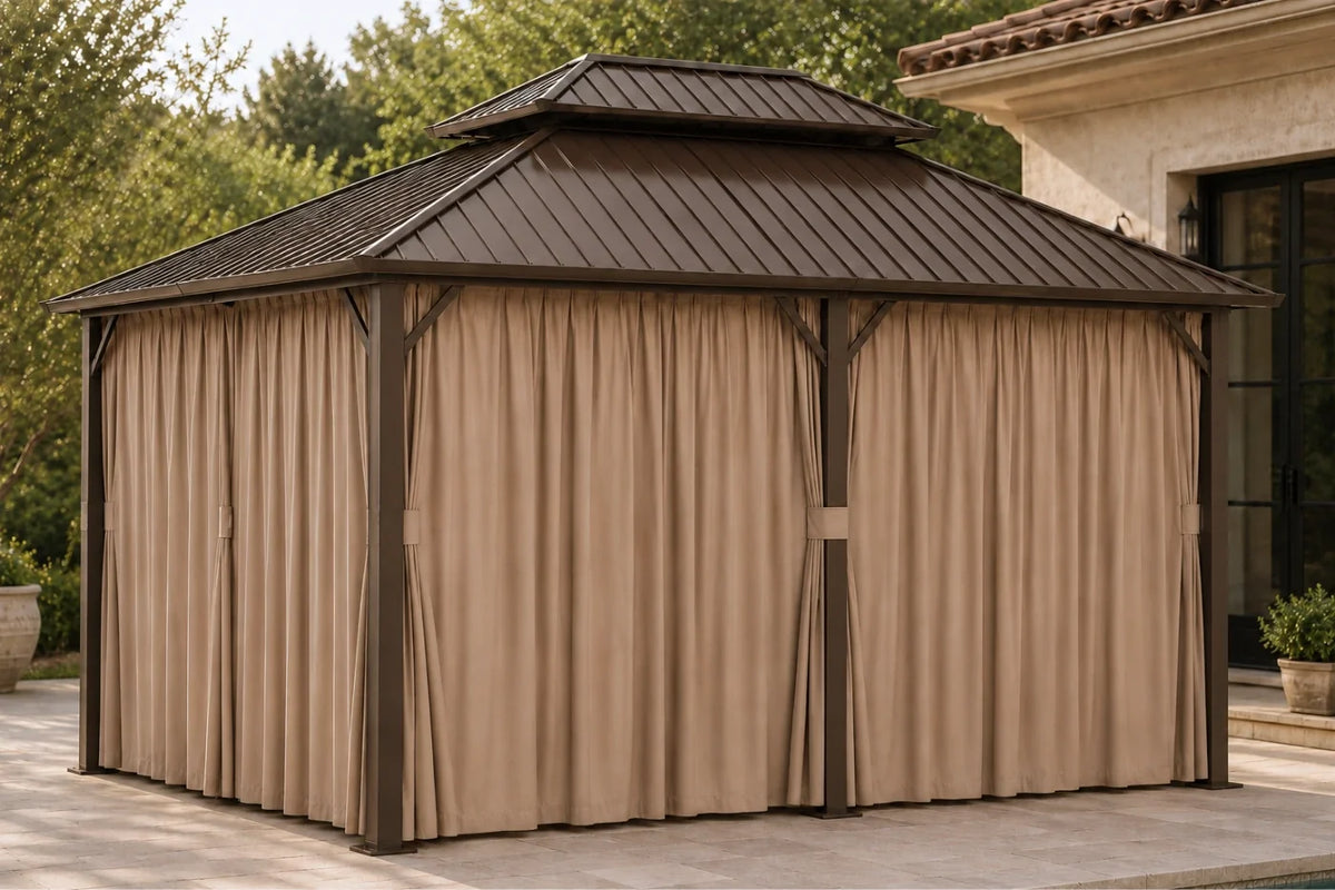 A covered hardtop gazebo with netting and curtains, shown on a patio in front of a house.