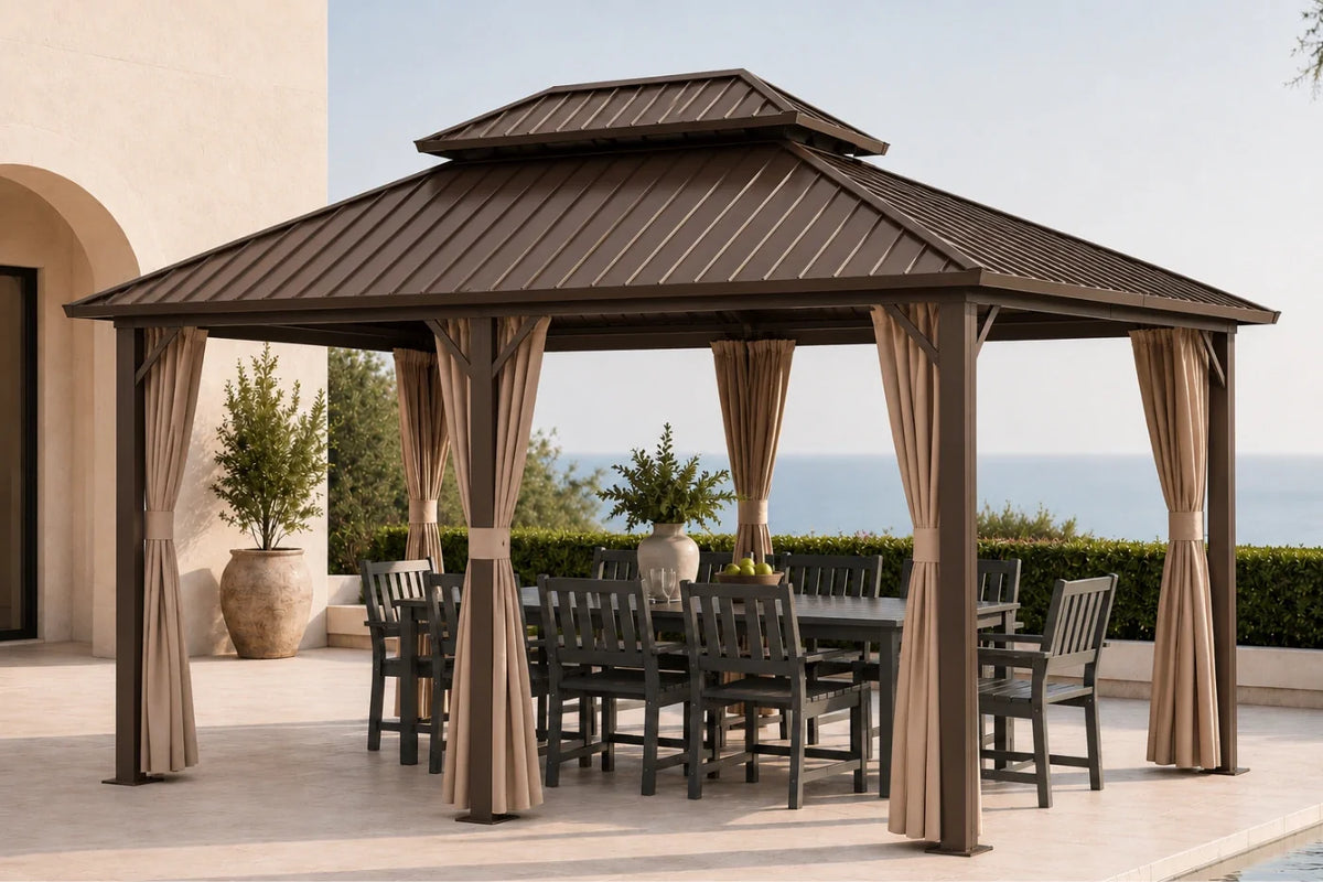 A brown hardtop gazebo with netting and curtains, shown on a patio with a dining table and chairs underneath. A beach and ocean are visible in the background.