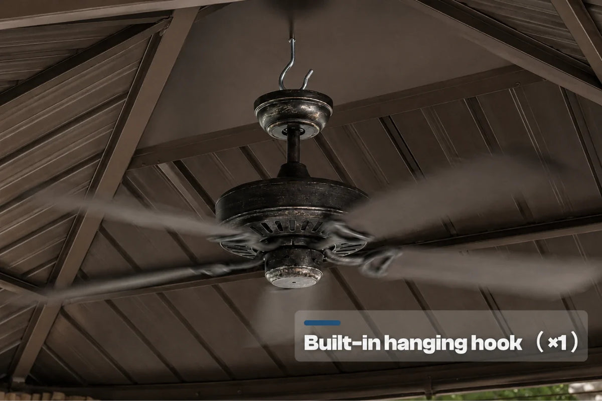 A dark five-blade ceiling fan hanging from a covered patio ceiling, with a text overlay that reads 'Built-in hanging hook (x1)'.
