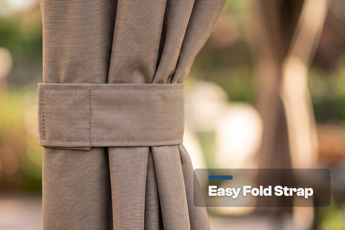 Close-up of a curtain tieback strap holding back pleated fabric, with a blurred outdoor background and an 'Easy Fold Strap' text overlay.