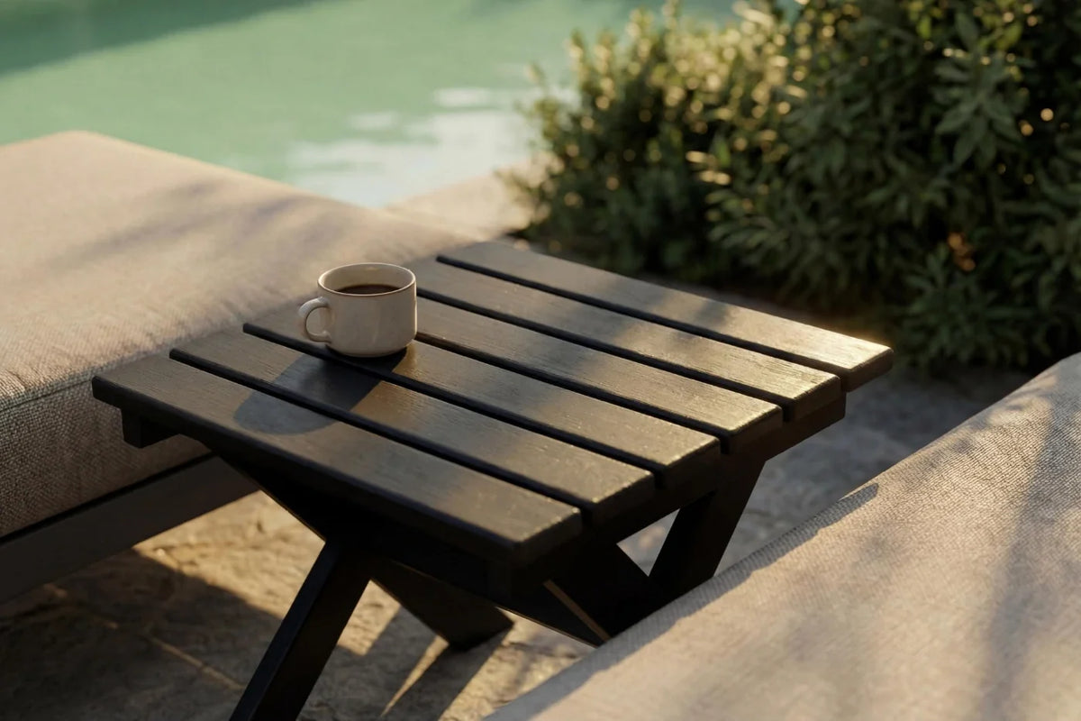 Wooden table with a cup on it by a poolside