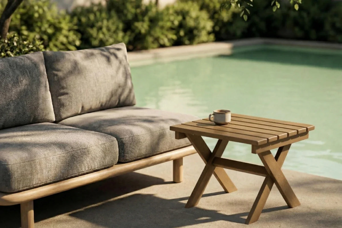 Outdoor furniture set with a sofa and side table by a pool