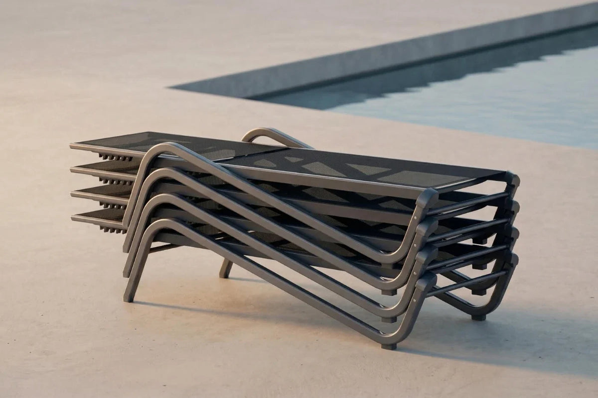 Stack of modern lounge chairs by a pool