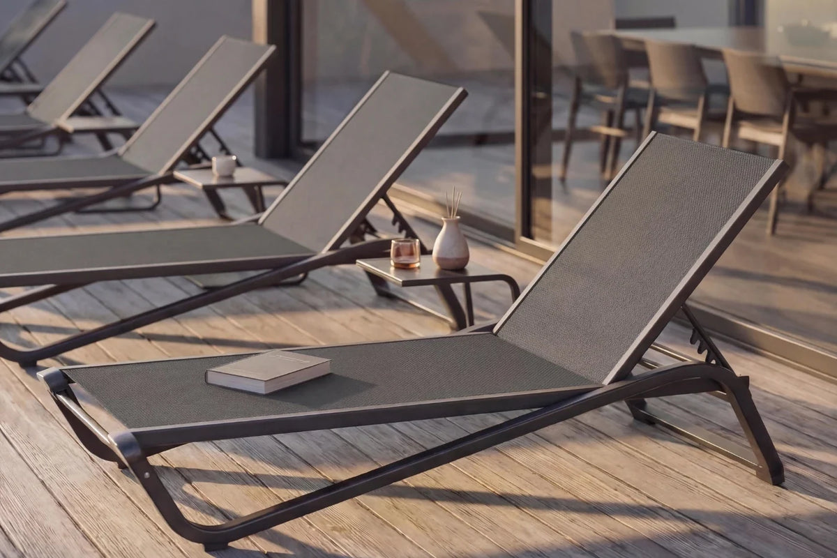 Sun loungers on a wooden deck with a blurred background