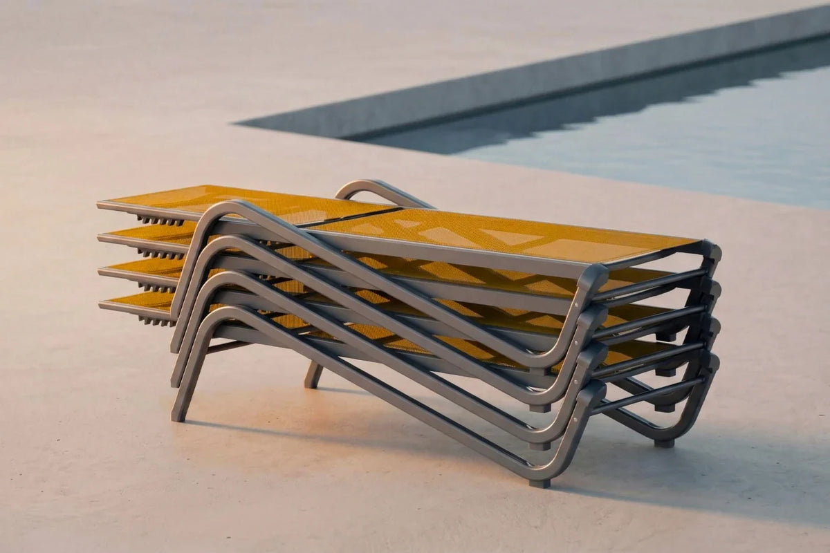 Stacked outdoor lounge chairs by a pool