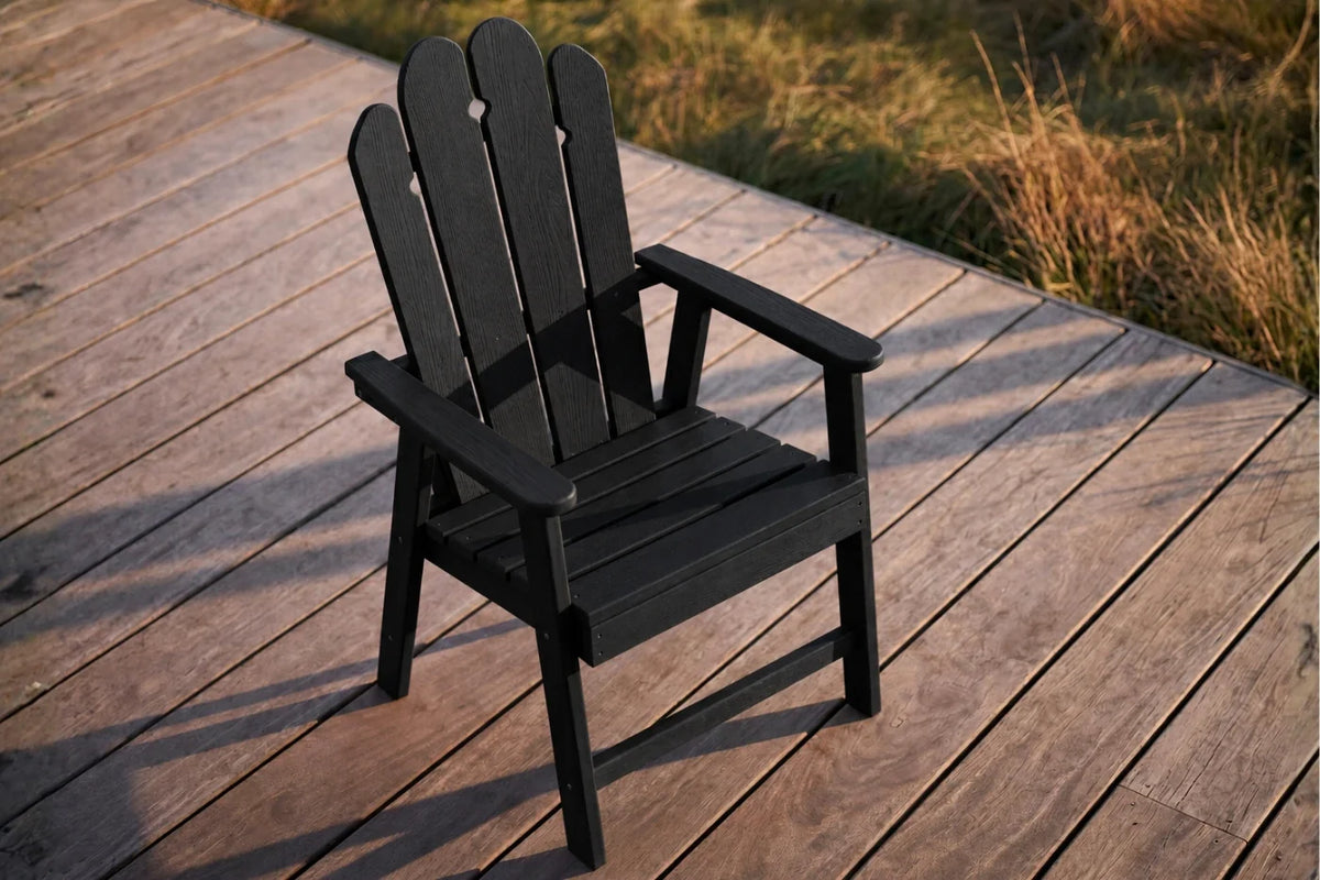 Black HDPE chair on a wooden deck with grass in the background