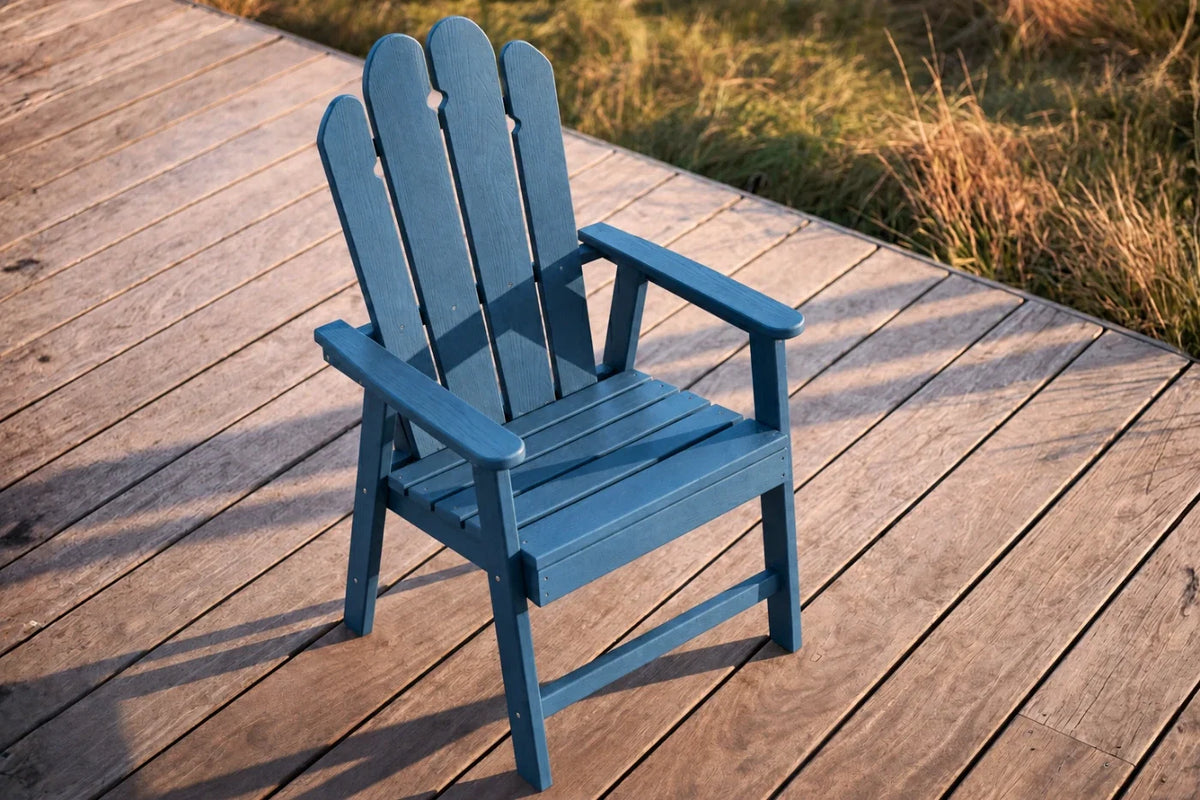 Navy blue HDPE chair on a wooden deck with grass in the background