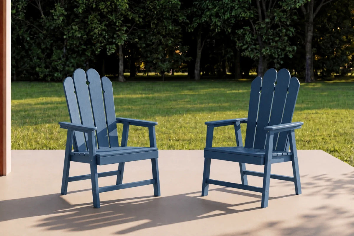 Two navy blue HDPE chairs on a patio with green grass and trees in the background.