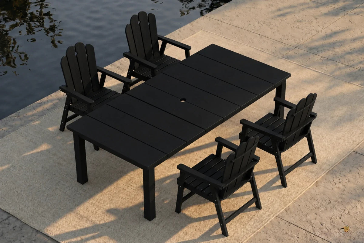 Black outdoor dining set with table and 4 chairs by a body of water.